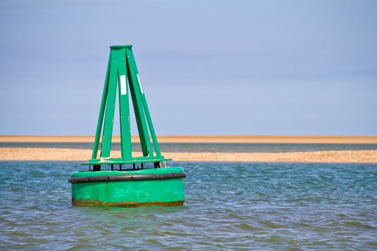 green cone shaped buoy mark